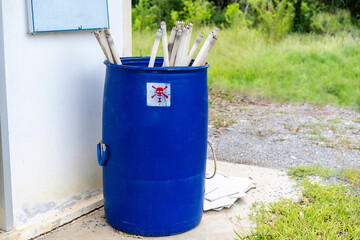 Image of a stack of disused and discarded neon lamp tubes waiting for recycling in the trash with...