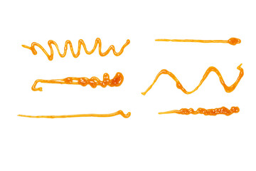 Orange apricot jam splashes isolated on white background. Top view.