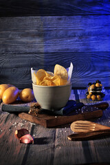 still life bowl of potato chips. Appetizers and snacks. culinary photography rustic and dark