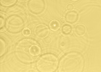 Subtle yellow texture of light-shadow pattern of sunlight reflection from rippled water surface. Beautiful natural pattern with 3D feeling. 