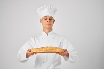 chef holding a loaf of fresh product in hand Professional Baker