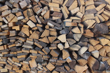Background texture of stacked firewood and boards
