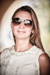 Young smiling woman in sunglasses