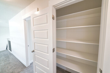 Fototapeta na wymiar Close up of the empty linen closet of home with wide shelves for storage