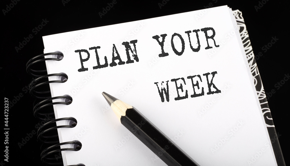 Poster plan your week written text in small notebook on a black background