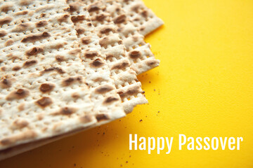 Traditional Jewish kosher matzo for Passover. Set with Passover matzos on yellow background. Pesach celebration. Happy Passover