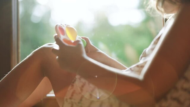 Stressful girl playing with popit simple dimple snapperz push pop bubble fidget toy. Children's hands play with the rainbow simple dimple snapperz pop it fidget toy