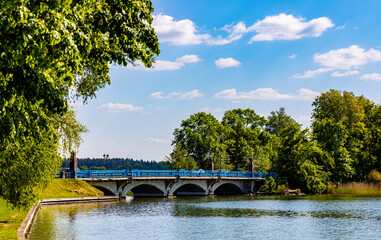 Panoramic view of Jezioro Elckie lake shores and strait with ulica Zamkowa street bridge to historic castle in Elk town in Masuria region of Poland