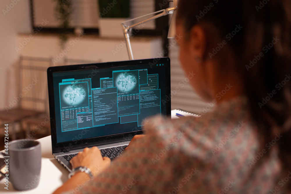 Poster woman doing cyberspace criminal activity hacking firewall using laptop from home office at night tim