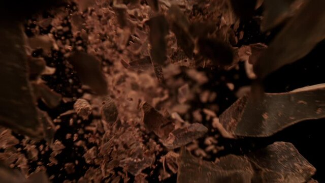 Super Slow Motion Detail Shot of Raw Chocolate Chunks Flying Towards Camera at 1000fps.