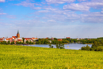 Panorama of Elk historic city center with Holiest Heart of Jesus neo-gothic church tower on shore...