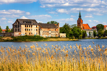 Panorama of Elk historic city center with Holiest Heart of Jesus church tower and Elk castle on shore of Jezioro Elckie lake in Masuria region of Poland