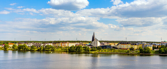 Panoramic view of southern town of Elk with St. Rafal Kalinowski church of Salesians order on shore of Jezioro Elckie lake in Poland