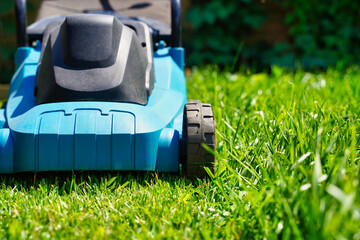 Lawnmower electric machine trimming green grass. Lawn cutting