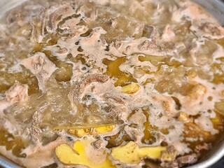 Boiling pork ribs with galangal or Lengkuas or Blue ginger