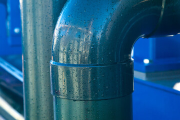 Large diameter plumbing painted steel pipe with welded seams and 90 degree bend.