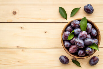 Purple plums in bowl. Plum harvest top view