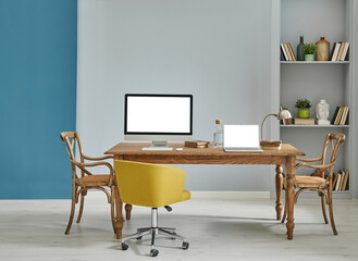 Decorative wooden furniture office room with computer and laptop style, retro cabinet and shelf background, blue and grey wall interior concept.