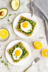 Open sandwich with eggs and avocado on plate. Overhead view