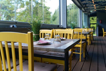 Setout table with tableware in modern restaurant in summer.