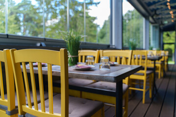 Setout table with tableware in modern restaurant in summer.