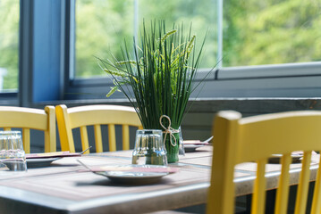 Setout table with tableware in modern restaurant in summer.