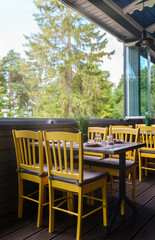 Setout table with tableware in modern restaurant in summer.