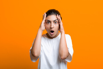 Portrait of young surprised scared adult indian woman in T-shirt