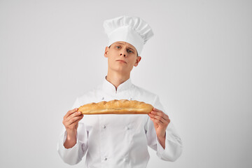 Cheerful man With a loaf in the hands of a professional snack fresh food
