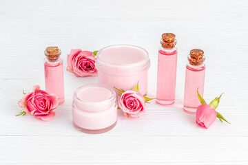 Essential rose aroma oil with cosmetic products for skin care