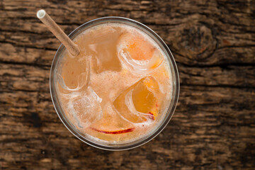 Homemade lemonade with peaches in plastic take away cup