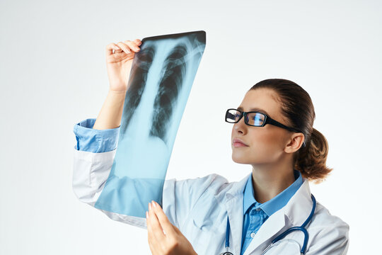 nurse looking at x-ray examination patient health