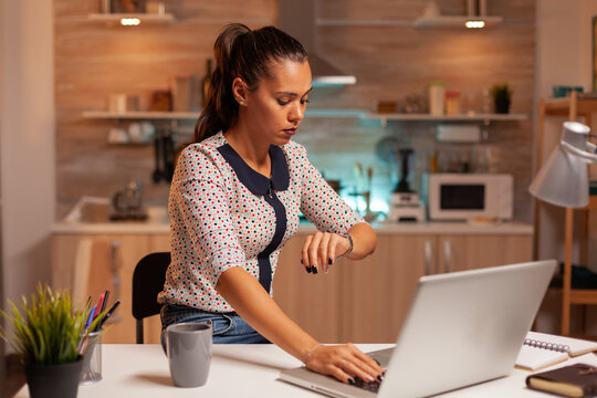 Businesswoman Checking Time On Watch While Working From Home. Employee Using Modern Technology At Midnight Doing Overtime For Job, Business, Busy, Career, Network, Lifestyle ,wireless.