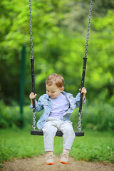 springtime, a boy in the spring swinging on a swing, leisure enjoyment childhood summer happy child