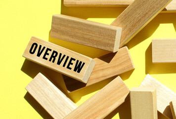 The OVERVIEW text is written on one of the many scattered wooden blocks, against a yellow background.