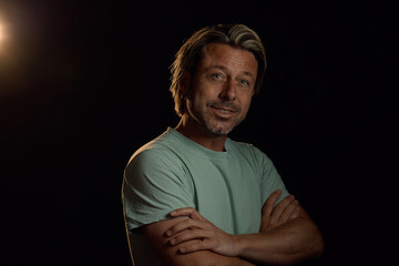 Naklejka premium Smiling man with blonde hair and a stubble beard in a light green t-shirt.