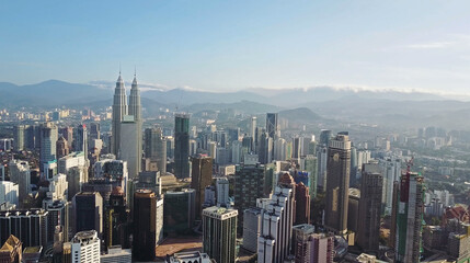 Naklejka premium Aerial view of Kuala Lumpur cityscape. Photo from a drone of Asian skyscrapers. All logos are blurred.