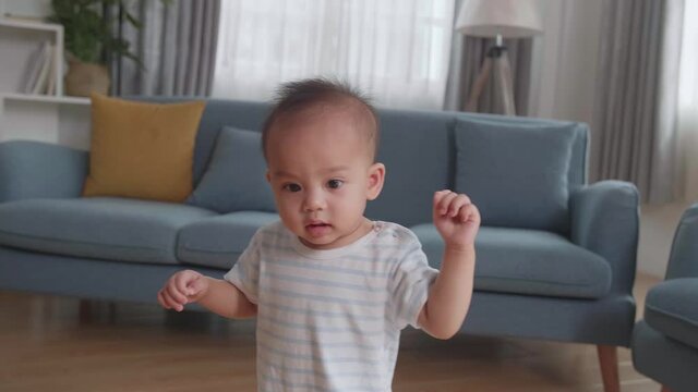 Baby Boy Learning To Walk At Home
