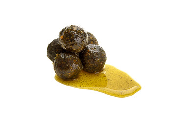 Close up view of green boilies in dip, fishing baits for carp isolated on white background