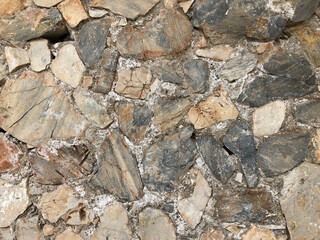 Old ancient wall with different stones as abstract background