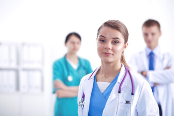 Fototapeta premium Attractive female doctor in front of medical group.
