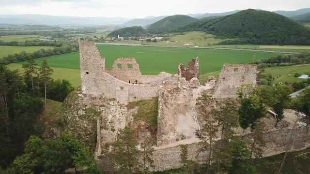 Reviste castle. The ruins of a Gothic castle located above the town of Žarnovica and Vtacnik mountain. Aerial footage.