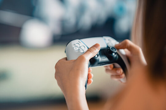 Closeup Hand of woman playing a computer games with joystick - Powered by Adobe
