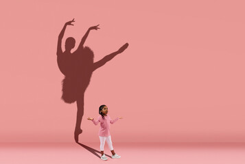 Childhood and dream about big and famous future. Conceptual image with girl and shadow of female...