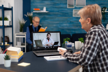 Sick senior woman talking with young doctor during remote consultation. Elderly telemedicine online conference call with practitioner doctor using modern healthcare technology, web diagnosis