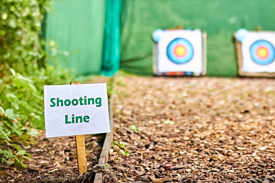 Archery shooting line waiting line targets ground at a low angle