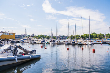 Fototapeta premium Stockholm Sweden - July 4 2021: Relaxing atmosphere in the port of Djurgarden. Sunny weather and peaceful atmosphere. Popular tourist destination in Scandinavia.