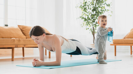 Young caucasian mother keeping fit shaping doing sport exercises at home, losing weight after labor...
