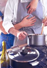 Couple cooking together in the kitchen at home