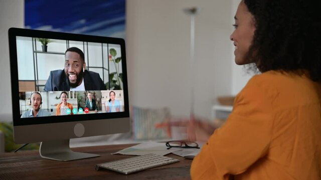 Video conference call on computer. African American successful young woman holding online meeting with multiracial colleagues, discussing working strategy and plans, talking vy video call